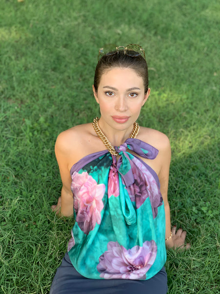 Our young model is wearing our scarf as a top. We paired it with a chunky, gold chain. Looks stunning to wear to a fancy party, or even a beach wedding. Pink and teal with a purple border. Silk scarf